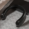 Black headphones on a textured surface with a blurred background