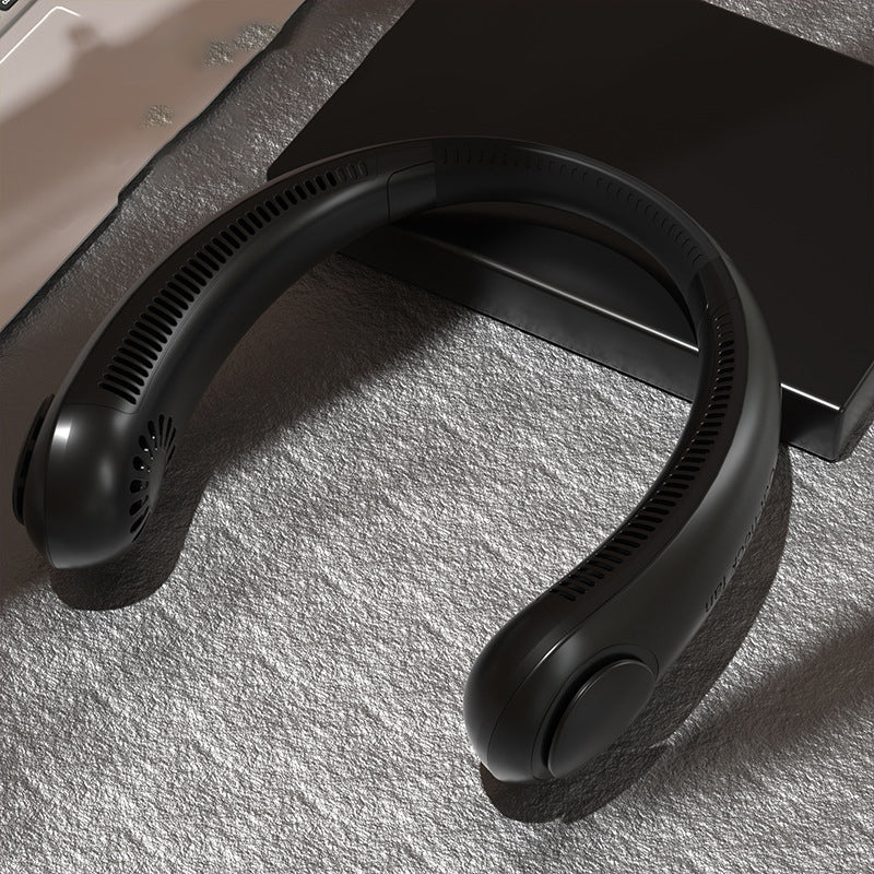Black headphones on a textured surface with a blurred background